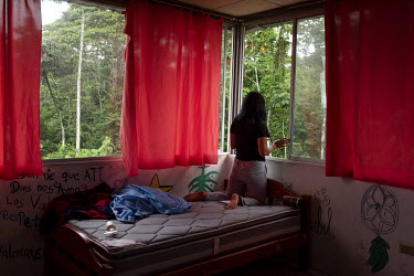 Karla (not her real name), a 17 year old teenage mother, looks out of the window at a shelter for women who have suffered domestic abuse where they are living. Ecuador has the second highest rate of t...