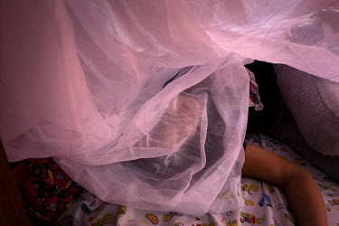 Karla (not her real name), a 17 year old teenage mother, rest in her room at a shelter for women who have suffered domestic abuse where they are living. Ecuador has the second highest rate of teenage...