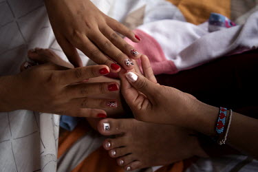 Cecilia and Silvana, not their real names, paint their nails in their room at the shelter for women who have been victims of gender based violence in Lago Agrio. Lago Agrio is a border city between Ec...