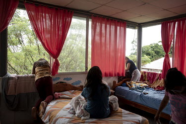 Women sit on their beds in a dorm room at a shelter for women who have been victims of domestic violence. Lago Agrio is a border city between Ecuador and Colombia and has one of the highest rates of d...
