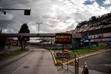 An electronic sign which reads 'Quedate En Casa' (stay at home) is seen along one of the main roads in Quito. People have been advised to stay at home in order to prevent the spread of Covid.
