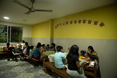 Women and children share dinner in the canteen of the centre for female victims of gender based violence. This year the shelter received more than one hundred new referals and provided them and their...