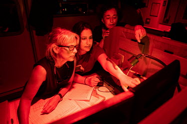 Kirsten Thompson, Mariajo Caballero and Juliana Costa examine nautical charts as the Greenpeace vessel Arctic Sunrise passes by a large group of sperm whales on the Saya de Malha Bank in the Indian Oc...