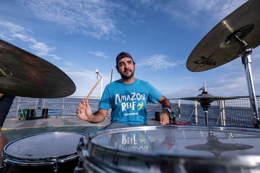 Third mate Mariano Rauleti plays drums on the helideck of the Greenpeace vessel Arctic Sunrise after work, during an expedition to survey the Saya de Malha Bank in the Indian Ocean.
