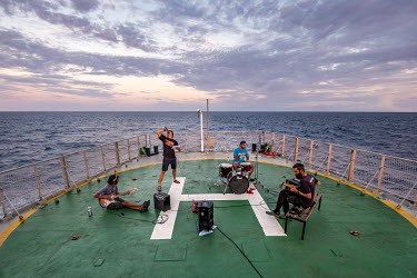 Band practice after work on the Arctic Sunrise during an expedition to survey the Saya de Malha Bank in the Indian Ocean.