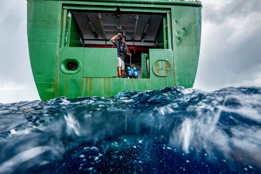 Greenpeace vessel Arctic Sunrise's radio operator Kristana Srithanomwong prepares to lower an underwater ROV into the water while documenting the Saya de Malha Bank in the Indian Ocean.