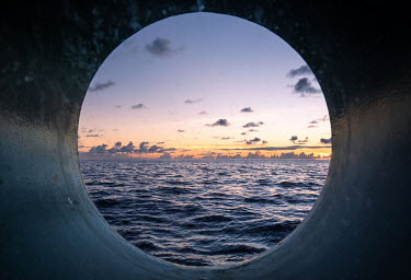 Sunset through a porthole on the Greenpeace vessel Arctic Sunrise.