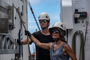 On Greenpeace vessel Arctic Sunrise, deckhands Lukas Scherhag and Laia Pascual prepare to deploy the gangway in Victoria, Seychelles.