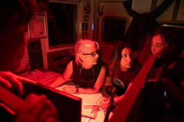 Kirsten Thompson, Mariajo Caballero and Juliana Costa in discussion as the Greenpeace vessel Arctic Sunrise passes by a large group of sperm whales on the Saya de Malha Bank in the Indian Ocean.
