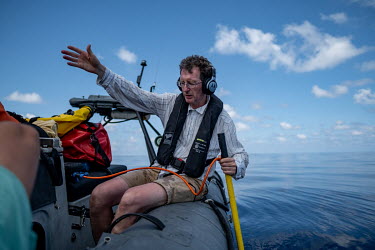 Marine acoustician Tim Lewis uses a directional hydrophone to track a group of sperm whales near the Seychelles.