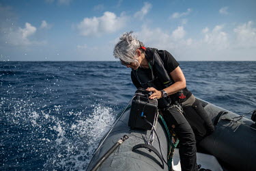 Marine scientist Dr Kirsten Thompson sets up her equipment to collect an eDNA sample on the Saya de Malha Bank in the Indian Ocean.