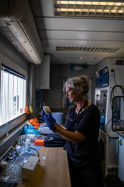 Marine scientist Dr Kirsten Thompson prepares an eDNA sample in the laboratory of the Greenpeace vessel Arctic Sunrise, at the Saya de Malha Bank.