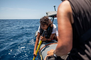 Scientist and climate activist Shaama Sandooyea uses a directional hydrophone to track sperm whales near the Seychelles.