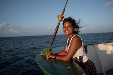 Climate activist Shaama Sandooyea at the bow of the Greenpeace vessel Arctic Sunrise.