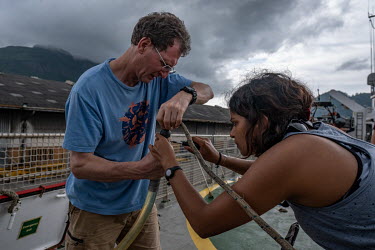 Marine scientist Tim Lewis and climate activist Shaama Sandooyea make minor repairs to a hydrophone in the port of Victoria, Seychelles, ahead of a ship tour on the Greenpeace vessel Arctic Sunrise in...