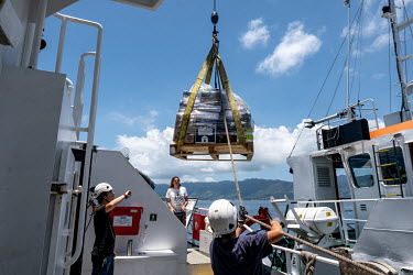 Provisions and equipment are loaded onto the Greenpeace vessel Arctic Sunrise outside Victoria, Seychelles.