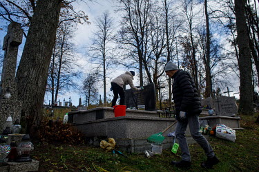 Family cleaning their relative's grave at the cemetery before All Saint's Day, by the entrance to the town inside the zone closed due to the state of emergency.   Thousands of migrants attempted to cr...