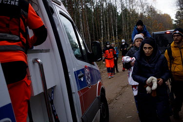 Syrian family getting help from volunteers and paramedics. They were wandering between borders for many days, pushed across the borders by the border guards.   Thousands of migrants attempted to cross...