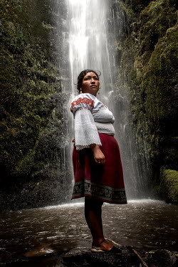 Gricelda Pupiales, 30 years old, poses for a portrait during her visit to the Rinconada waterfall. She is a Karanki woman, a guardian of the water. She takes weekly walks for garbage collection, fire...