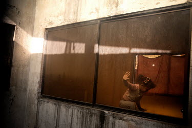 Rosveri Johana plays in her room. Since the quarantine began she and her family have not left home. She has found a place in the corner to play.  The family fled from Venezuela and both parents lost t...