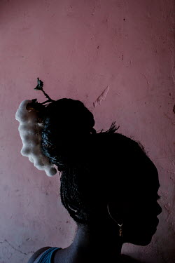 Nicole Gudino, 19, wears a cotton plant in her hair. The enslaved Africans who came to Ecuador were forced to work in cotton fields and coal mines. For Nicole, cotton plants represent the strength of...