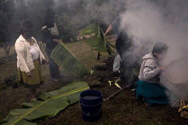 A group of indigenous Karanki people celebrates the pachamanka, an indigenous ritual in which food is cooked in the ground and then shared with the entire community to celebrate.