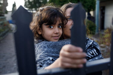 Bialystok, Poland, 13.11.2021: Judyta, a Polish volunteer playing with Zahra, 6, from Iraq, an illegal migrant who with her family crossed the border from Belarus, at the centre for migrants in Bialys...