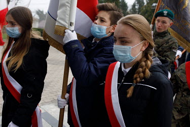 Local youths march with the Polish flag before a mass for the anniversary of Polish Independence in Sokolka. The town is situated near the state of emergency zone by the Belarussian border. Hundreds o...