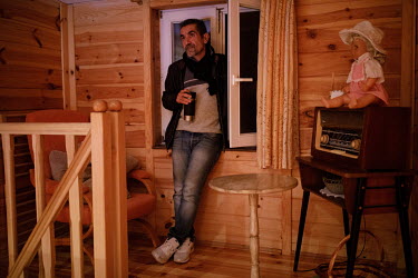 Iraqi activist Aras Palak at his office in a rented house near the state of emergency zone by the Belarussian border. He is trying to help a migrant stuck in the forest. Hundreds of migrants, mainly f...