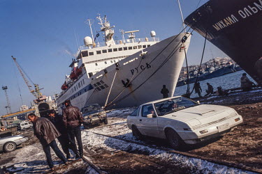 Japanese used cars are offloaded in Vladivostok harbour. After the end of the Soviet era Vladivostok entrepreneurs saw used Japanese cars as a big money making opportunity. With Japan's northern islan...