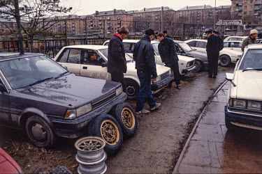 People inspect Japanese used cars in Vladivostok.  After the end of the Soviet era Vladivostok entrepreneurs saw used Japanese cars as a big money making opportunity. With Japan's northern island of H...