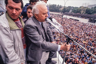Georgian President Eduard Shevarnadze addresses a large crowd from a balcony of the Abkhazian parliament. He is assuring them that the Georgian army will protect them from rebel forces surrounding the...