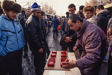 A man plays a dice game on the streets of Vladivostok hoping to get passersby to bet on the outcome. After the end of the Soviet era everyone was looking for ways to make money and survive in the new...