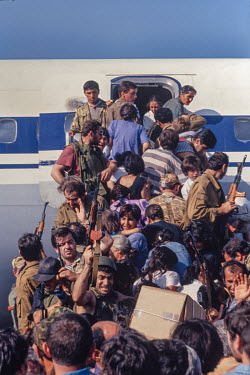 Desperate civilians try to storm onto a plane at Sukhumi airport as it was being being shelled by advancing separatist rebels at the same time as Georgian army reinforcements who have been flown in fr...