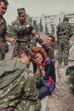 A woman is comforted by Russian soldiers after being told her husband has been killed in Transnistria separatist fighting in 1992.  Moldova gained its independence, along with all the other former S...