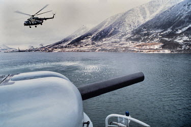 A Russian border forces helicopter approaches a warship in the Bering Sea, one of the closest points to the United States.