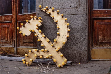 A hammer and sickle neon sign sits on the pavement after being removed from Moscow's Central Telephone exchange for the last time in 1991.