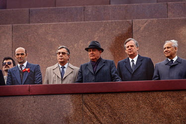 General Secretary of the Communist Party Mikhail Gorbachev, along with other Party leaders, looks down onto Red Square from the top of Lenin's Mausoleum on May Day 1990. Below him are public supporter...