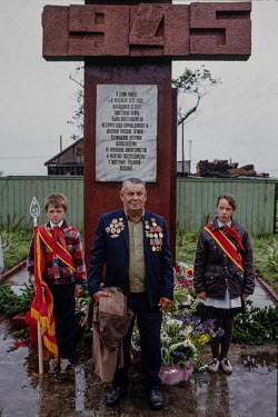 A war veteran and two young pioneers during a 45th anniversary celebration of the Soviet Union's victory over fascism on the southernmost of the Kuril islands directly North of Japan.