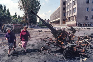 Two women walk past a destroyed artillery piece in Tirasopol. Moldova gained its independence, along with all the other former Soviet Republics following the collapse of the Soviet Union in 1991. As i...