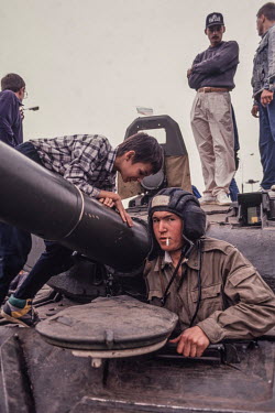 A soldier looks out of a tank as Russians bring food to tank crews, and climb on their tanks, outside the Russian Parliament in August 1991 following the failed Russian coup. The refusal of tank comma...