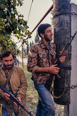 Two members of the Georgian Army look for snipers in the hills around Sukhumi during the Abkhazian War in 1993.   Abkhazia was a break away autonomous region inside Georgia. After gaining its indepe...