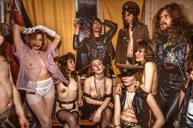 Topless dancers, who performed as part of a heavy metal rock concert, backstage with members of the band. As the Gorbachev era of increased social freedom progressed, prior to the collapse of the Sovi...
