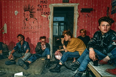 A group of punks drinking and sniffing glue in an abandoned building where they're squatting next to Pushkin Square. They survive by begging and Pizza Hut and McDonald's rubbish bins. This kind of act...