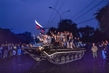 Pro-democracy supporters ride on top of an armoured personnel carrier with a Russian flag during the attempted coup in August 1991 by hardline Communists opposed to Gorbachev and Yeltsin's reforms. Th...