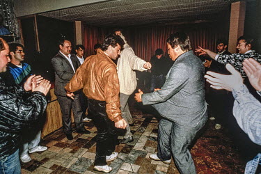 Men dancing in a Georgian restaurant in Moscow that was suspected of being a mafia front and hangout. With the collapse of the Soviet Union and the end of surveillance by the KGB, coupled with econom...