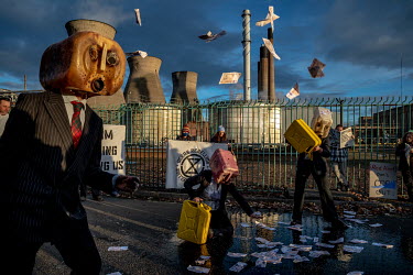 Members of Ocean Rebellion protest outside Grangemouth Oil Refinery. Oil Head Performers vomited fake oil to protest the fact that so many jobs in Scotland are reliant on fossil fuels.