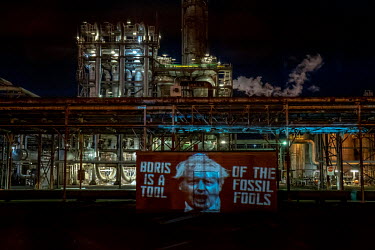 Ocean Rebellion project an image of Boris Johnson onto Grangemouth Oil Refinery.