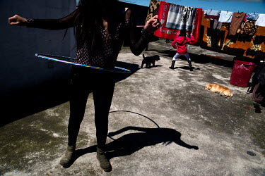 Carolina Molina, a teacher, records a video of hoola hooping to send to her students.  Carolina, 29, is a teacher and assistant director of a state school in the south of Quito. She manages teachers...