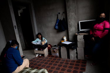 Anahi Cadena, 11 years old, does her homework with her mum and her older sister. They pay 5USD a week on pay as you go internet to download their assignments and classes on WhatsApp.  María Cecilia...